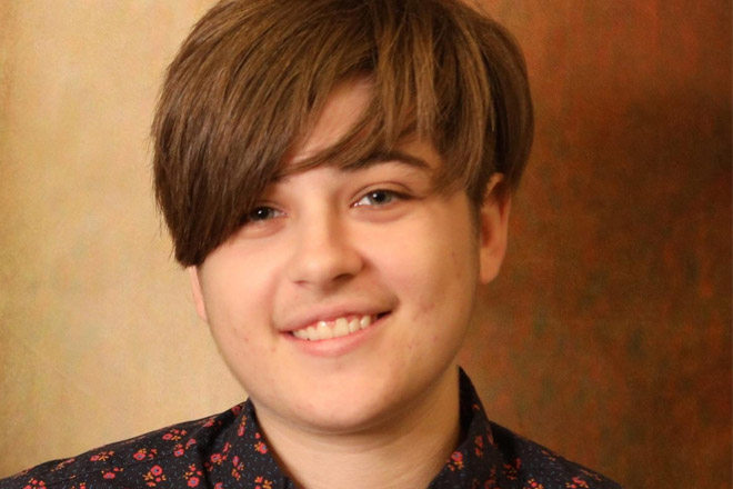 A student looking and smiles