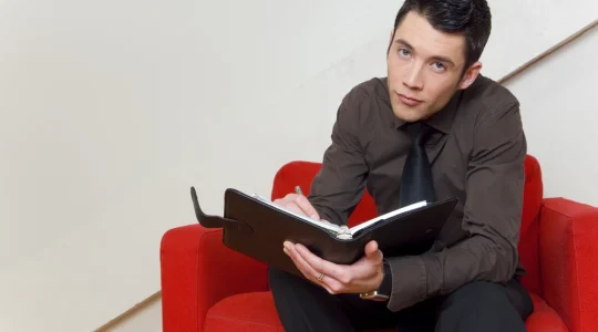 A young adult using a planner to create a routine to help with executive functioning