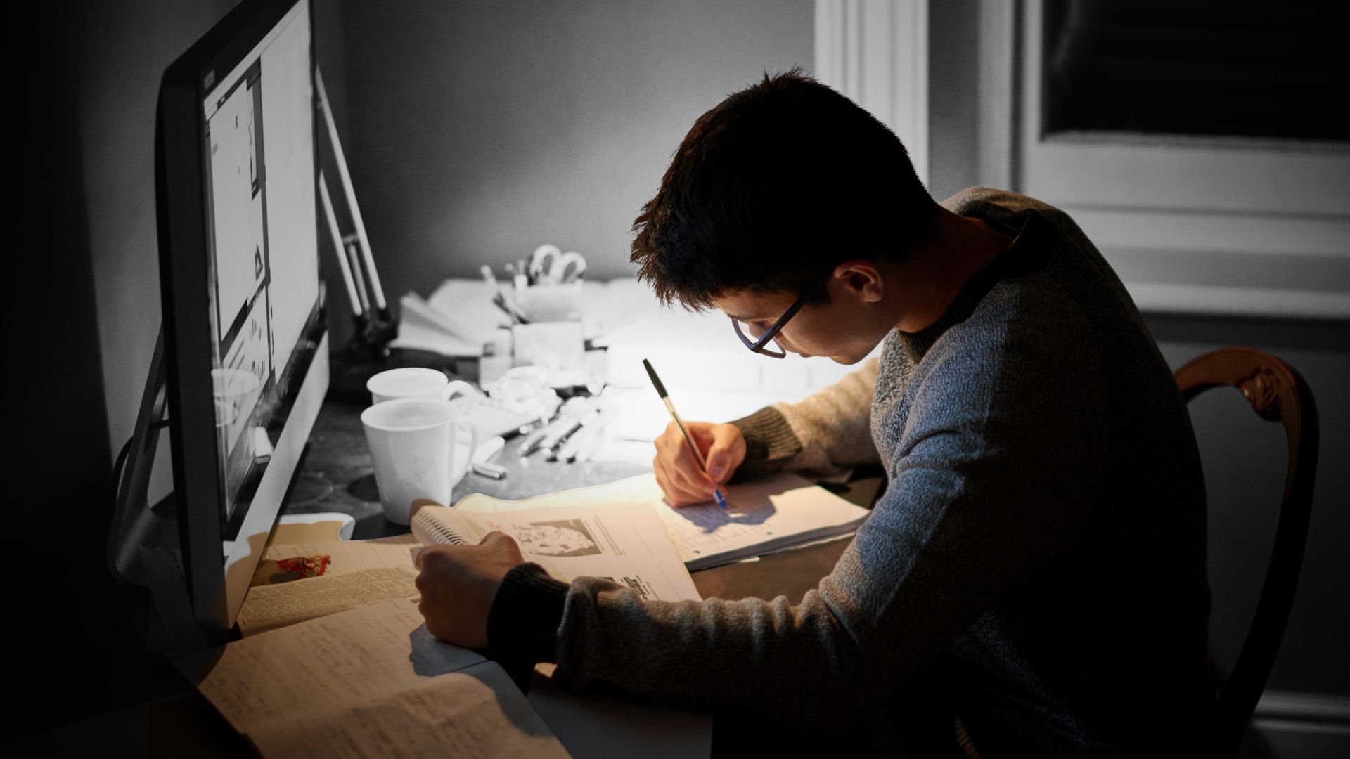 Student doing homework at their desk at night